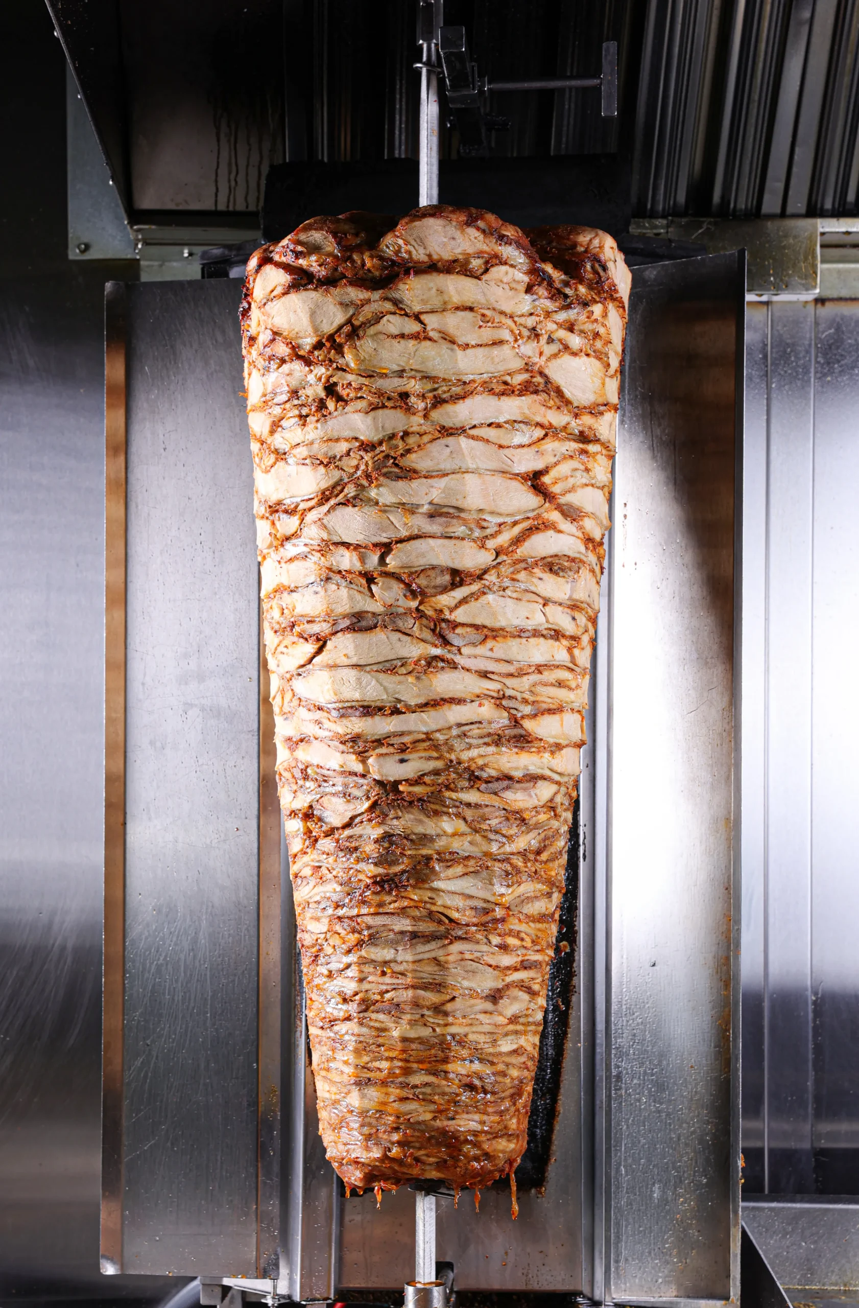Shawarma wraps and sliced meat on a serving platter